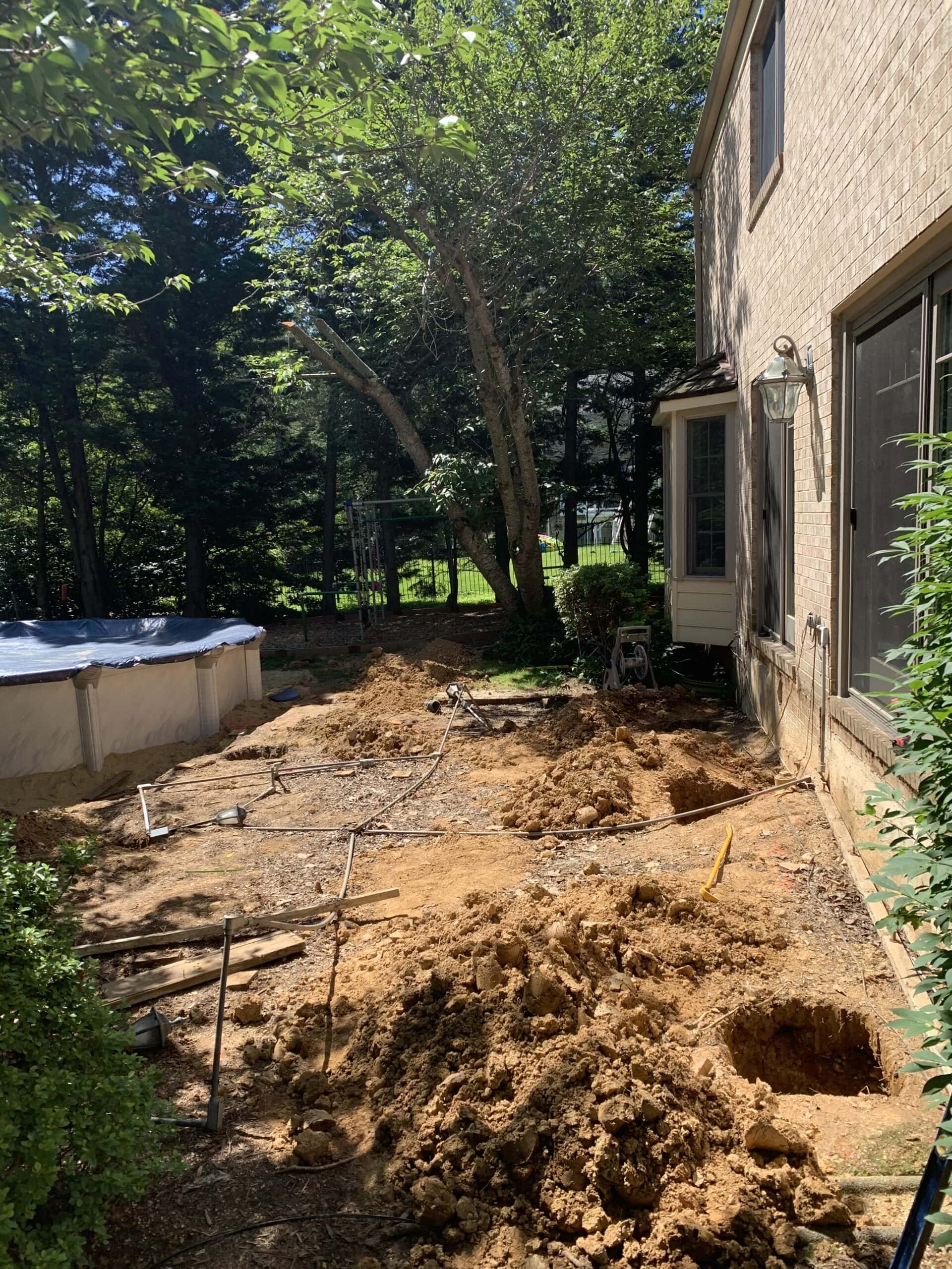 Excavation and site preparation for custom Trex deck around an above-ground pool
