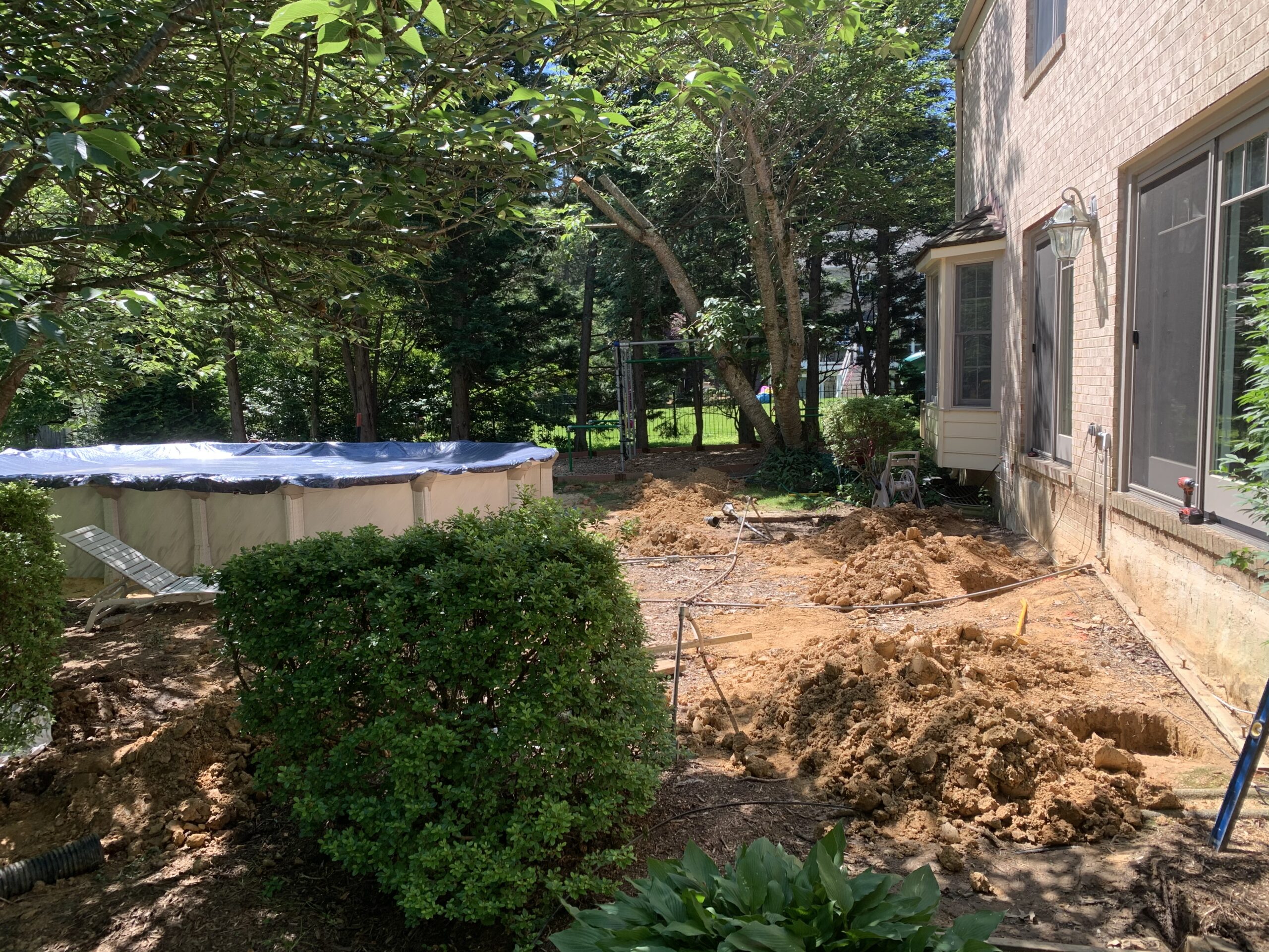Clearing and leveling the backyard area before deck framing begins