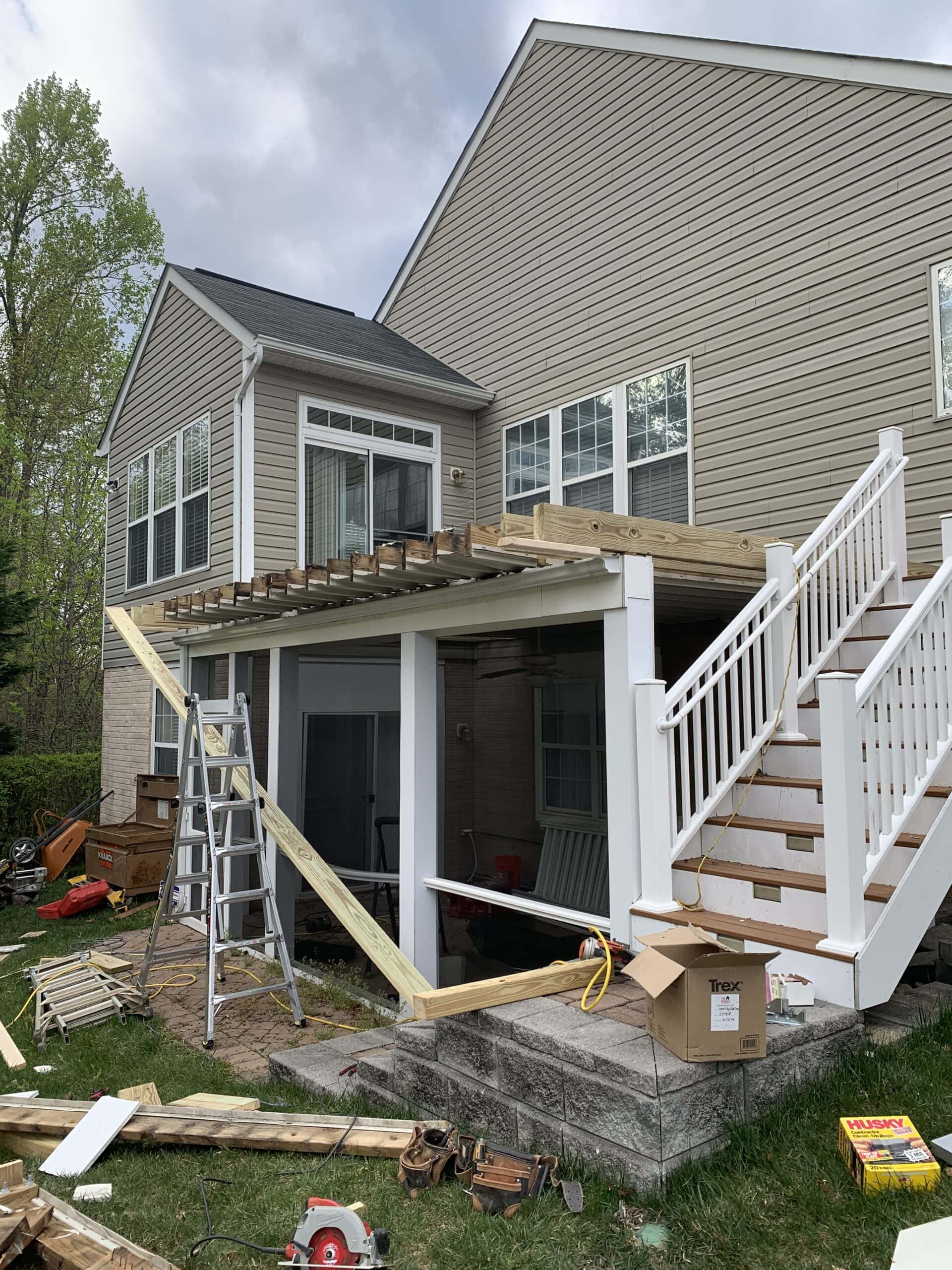 Construction begins on elevated three-season porch with stairs removed and framing in progress