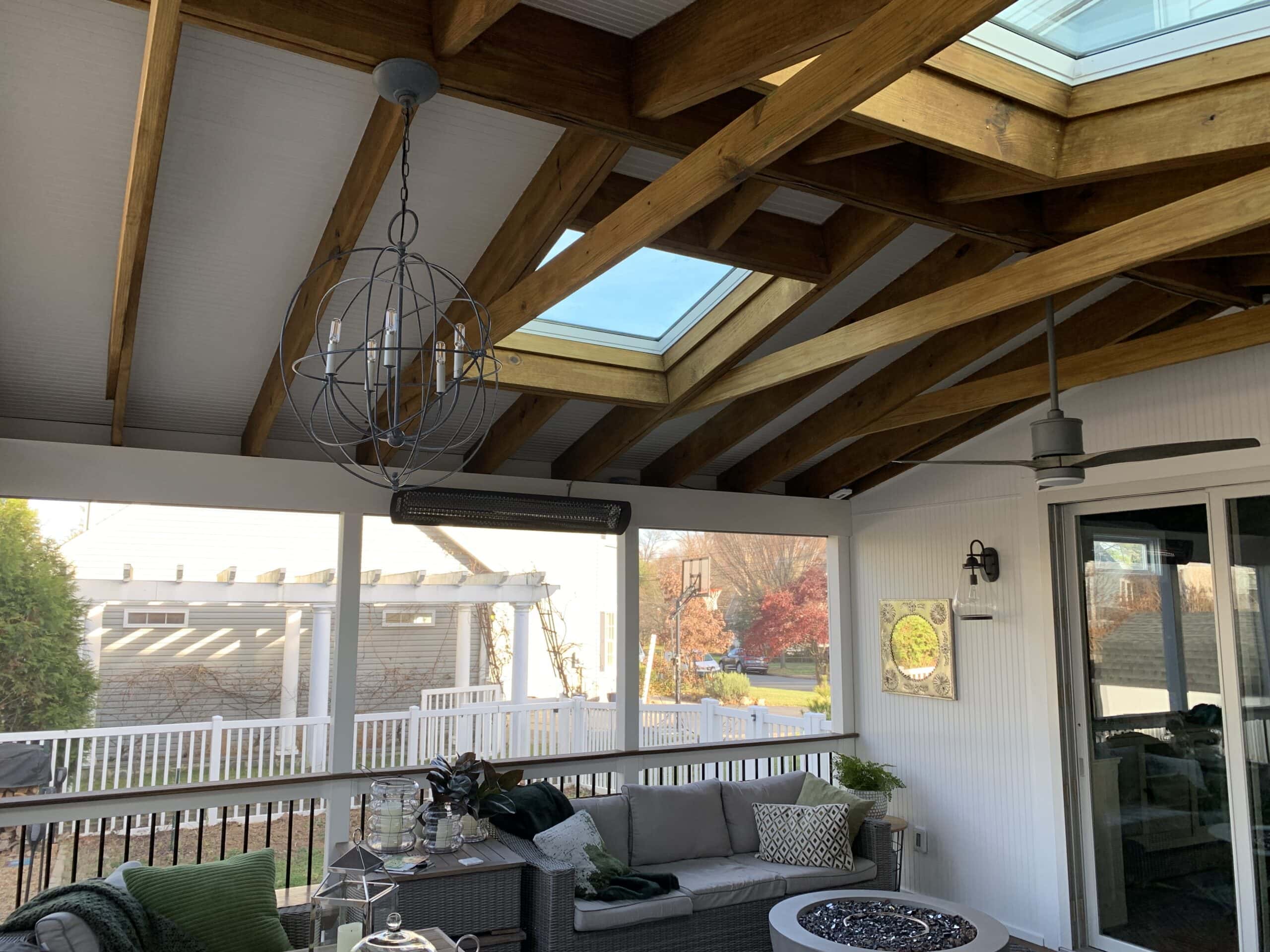 A sunroom with a skylight and patio furniture.