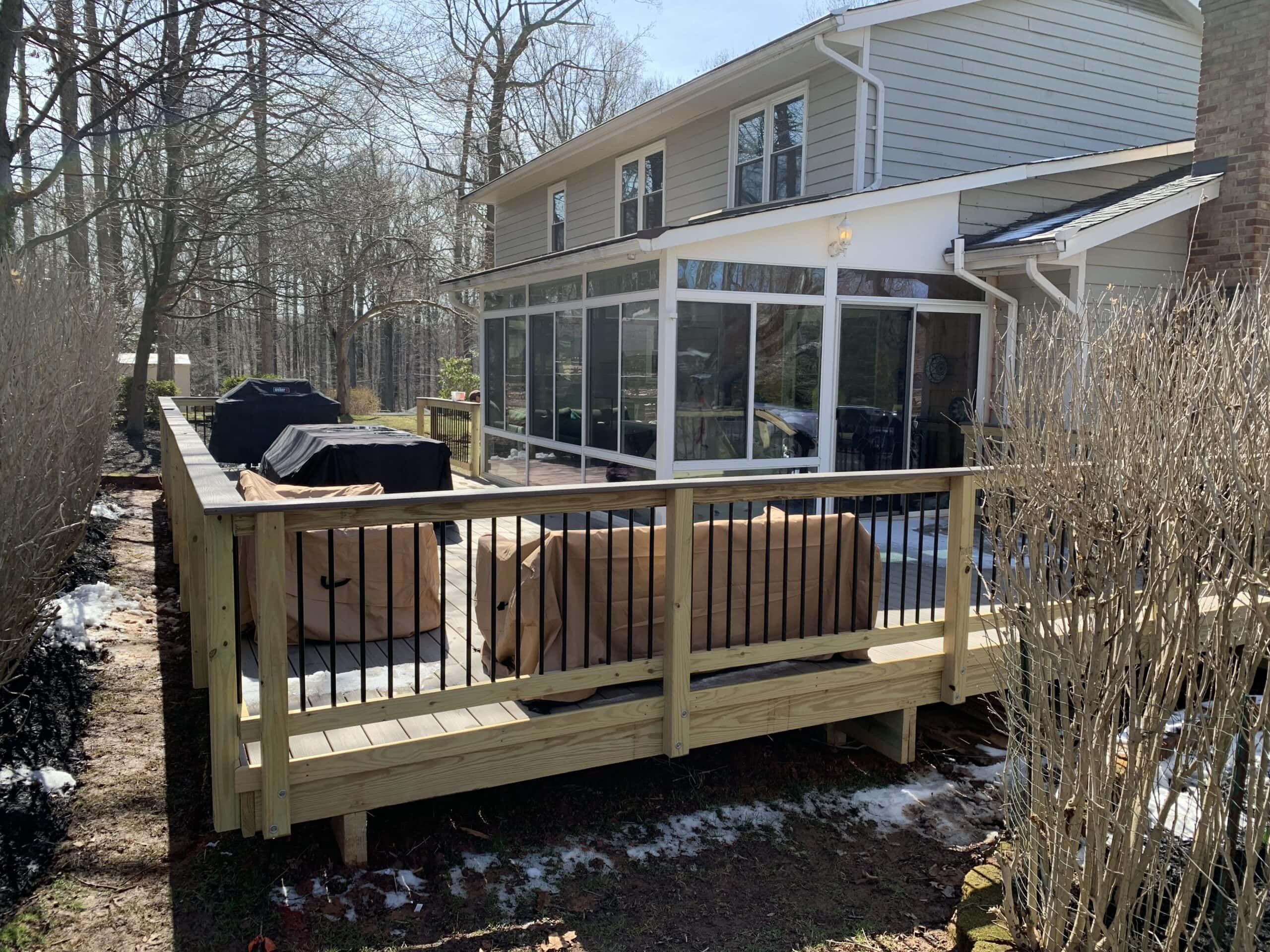 A deck with a grill and a patio area.