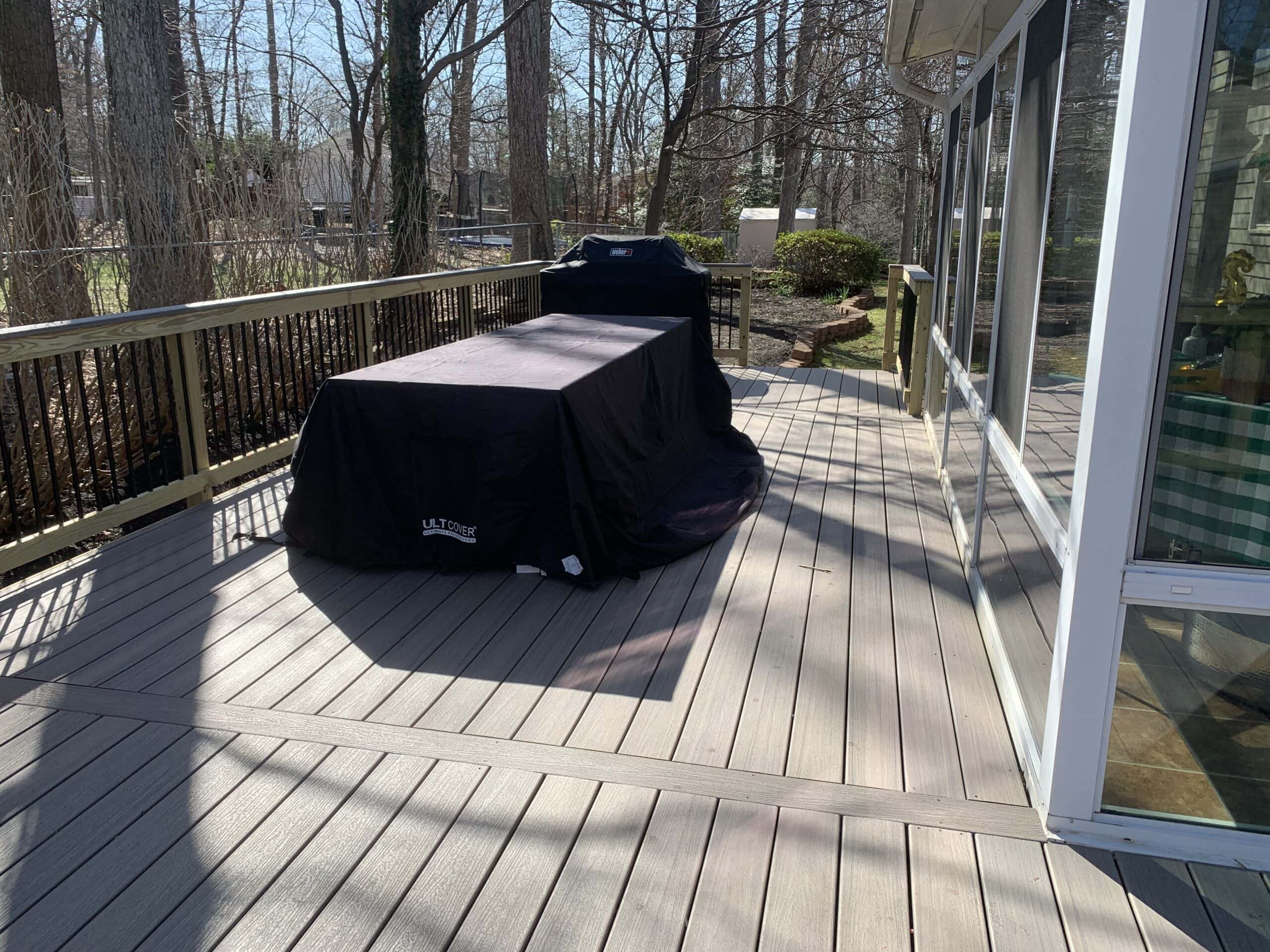 A house with a porch and a deck being built.