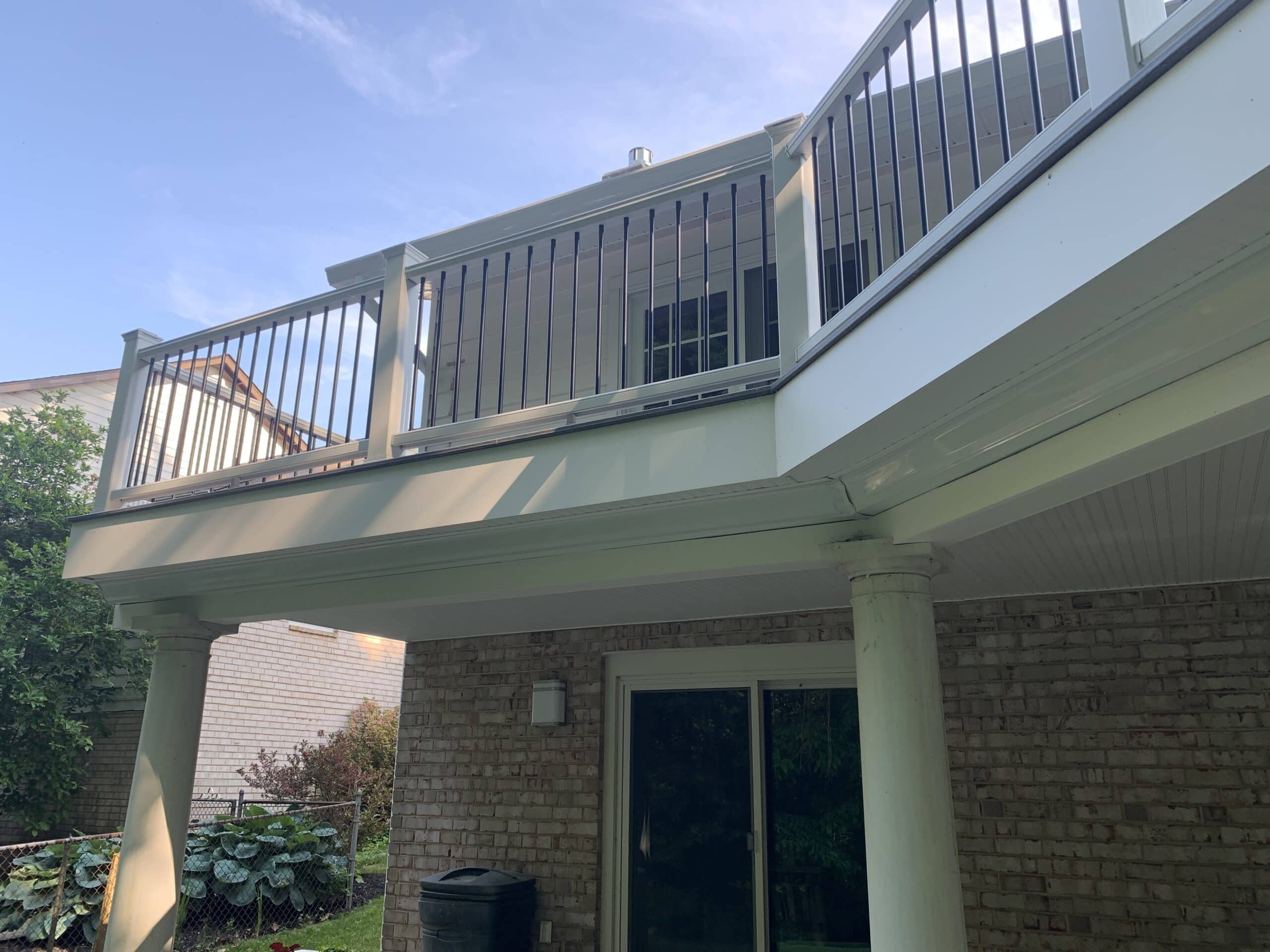 A deck with a balcony and railing.