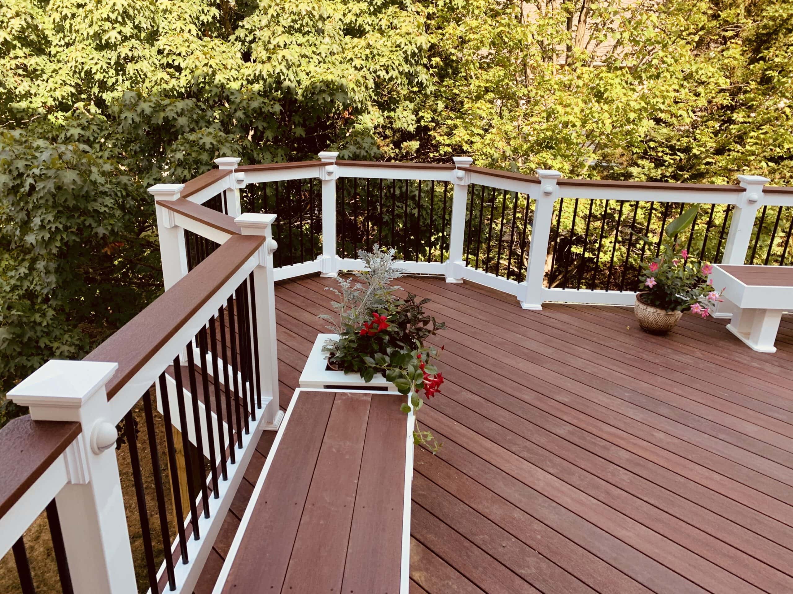 A deck with a bench and railing.