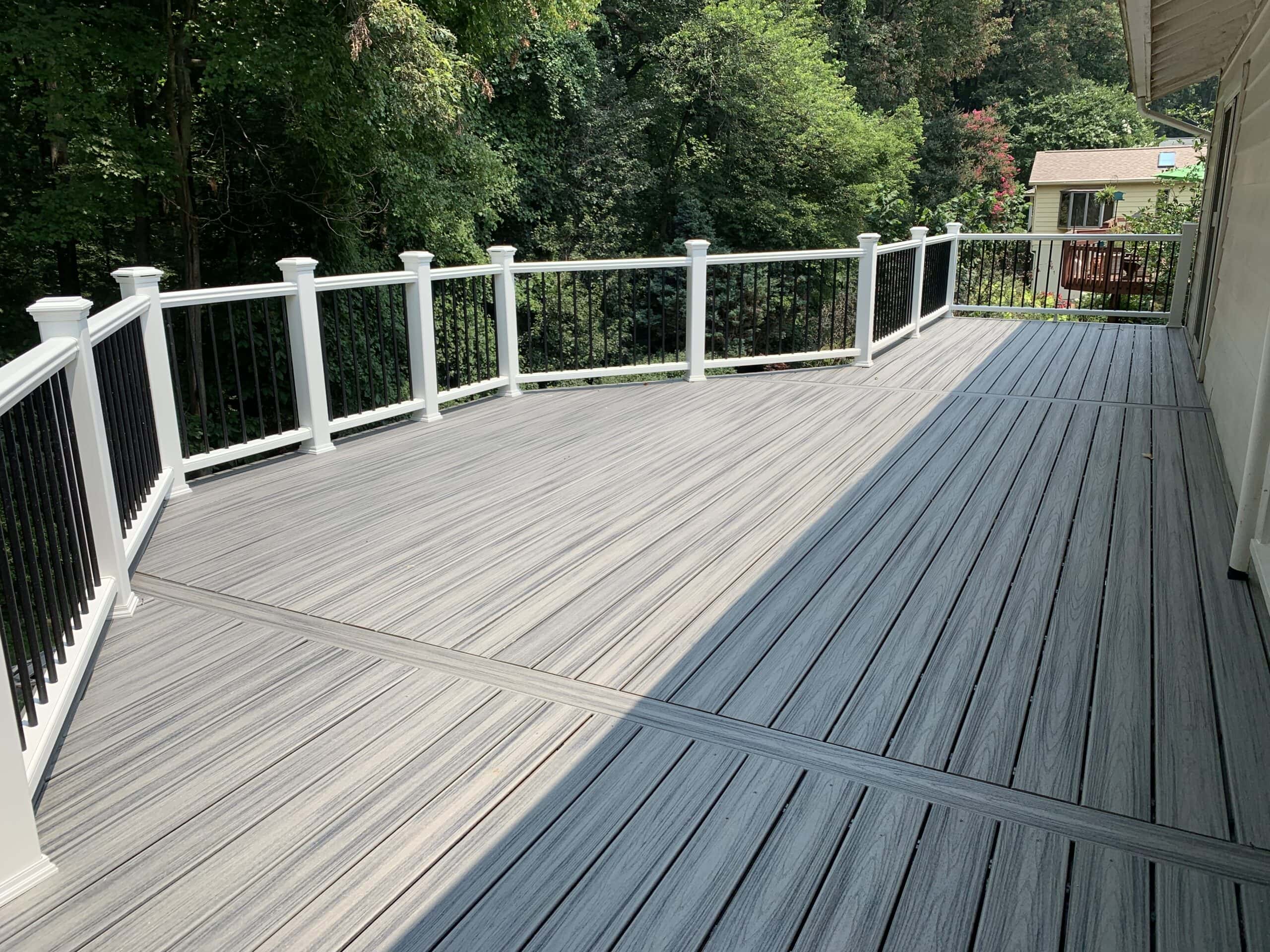 A deck with white railings and a railing.