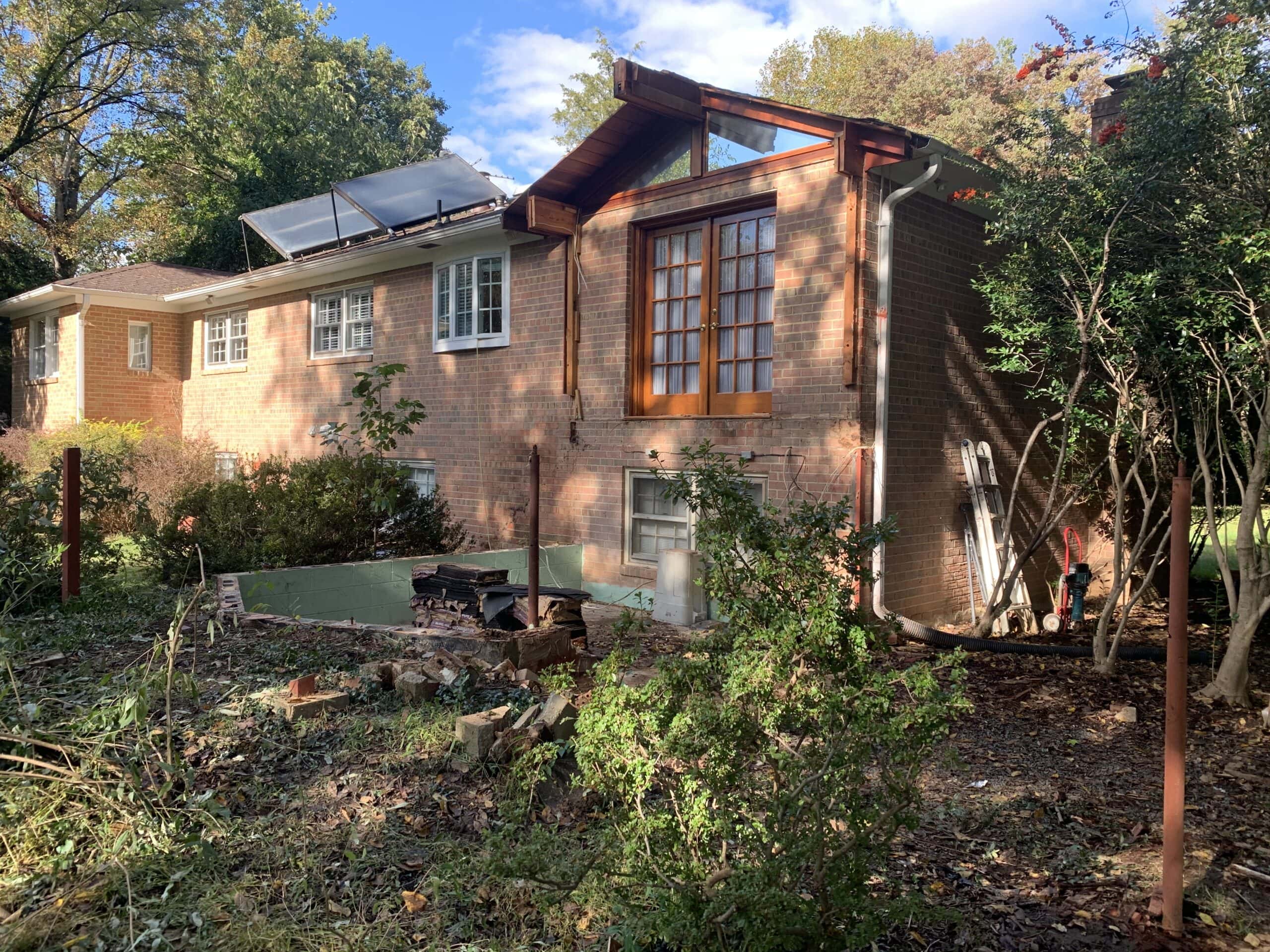 Partial demolition of the old addition underway, clearing the area for the new three-season room.