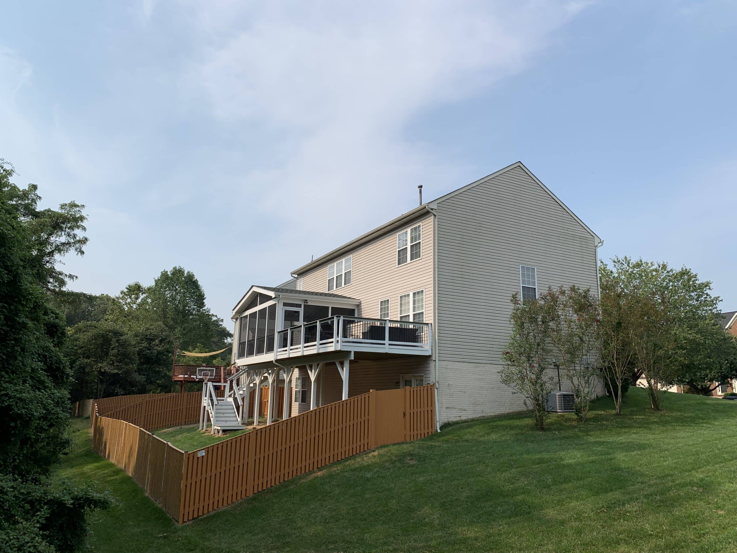 A house with a deck and a fence.