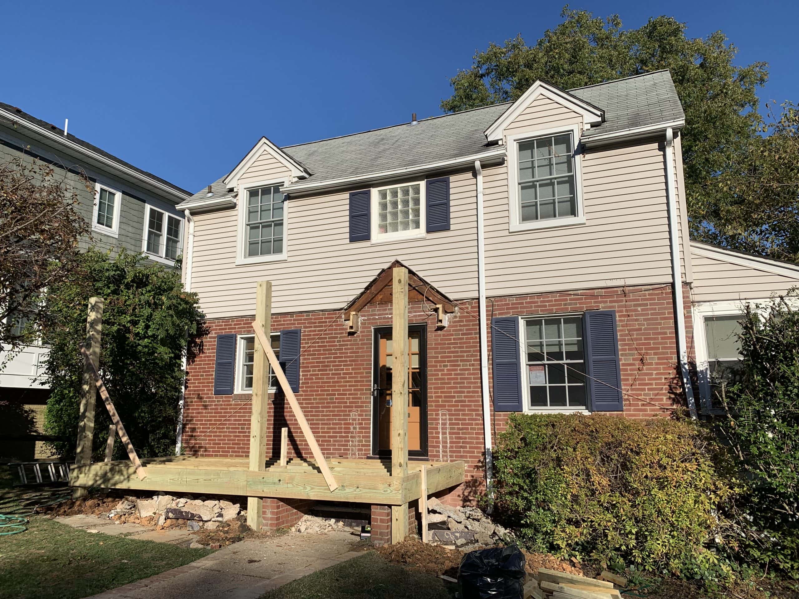 A house with a wooden deck and a wooden porch.