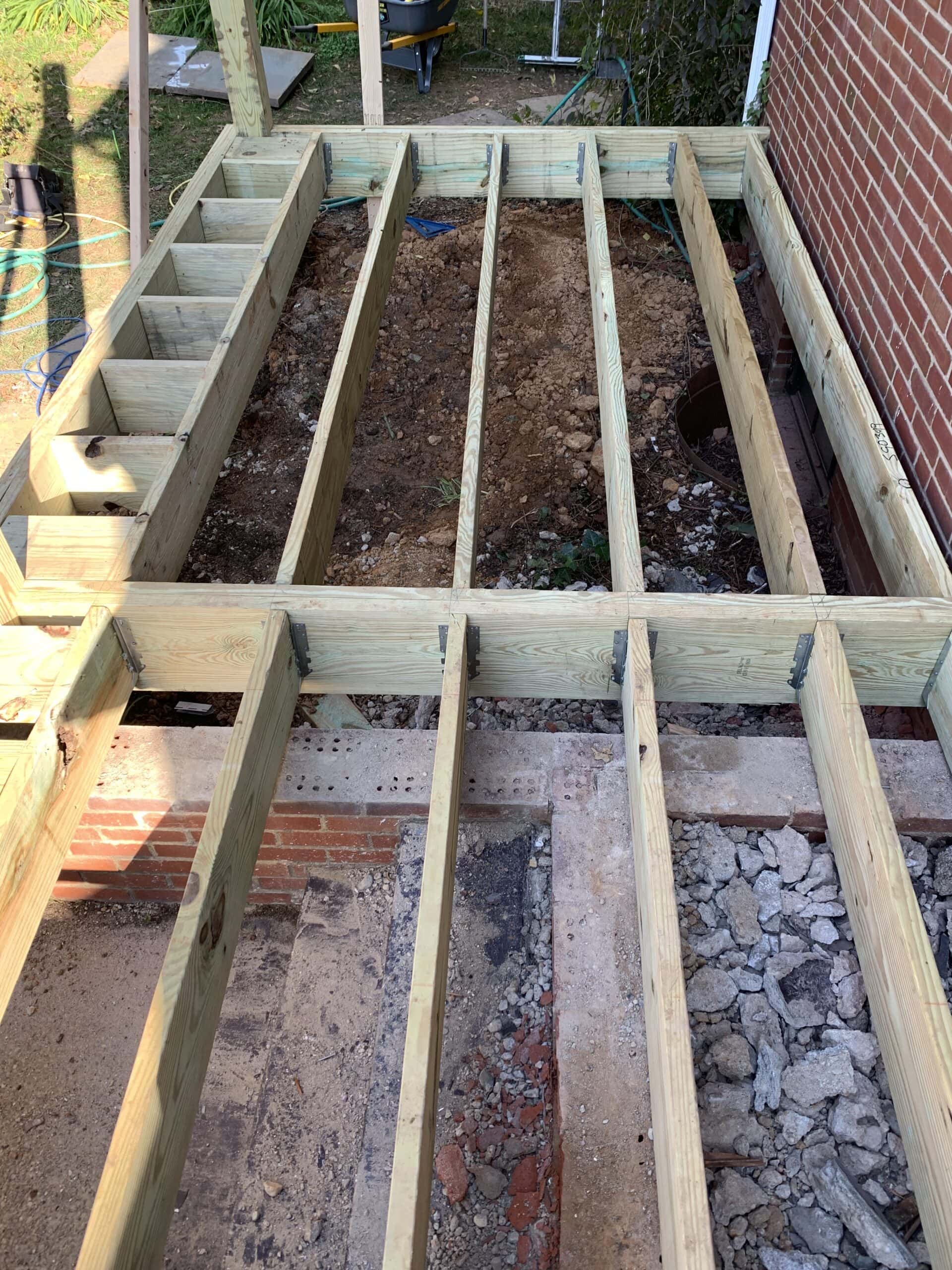A deck being built with wooden beams.