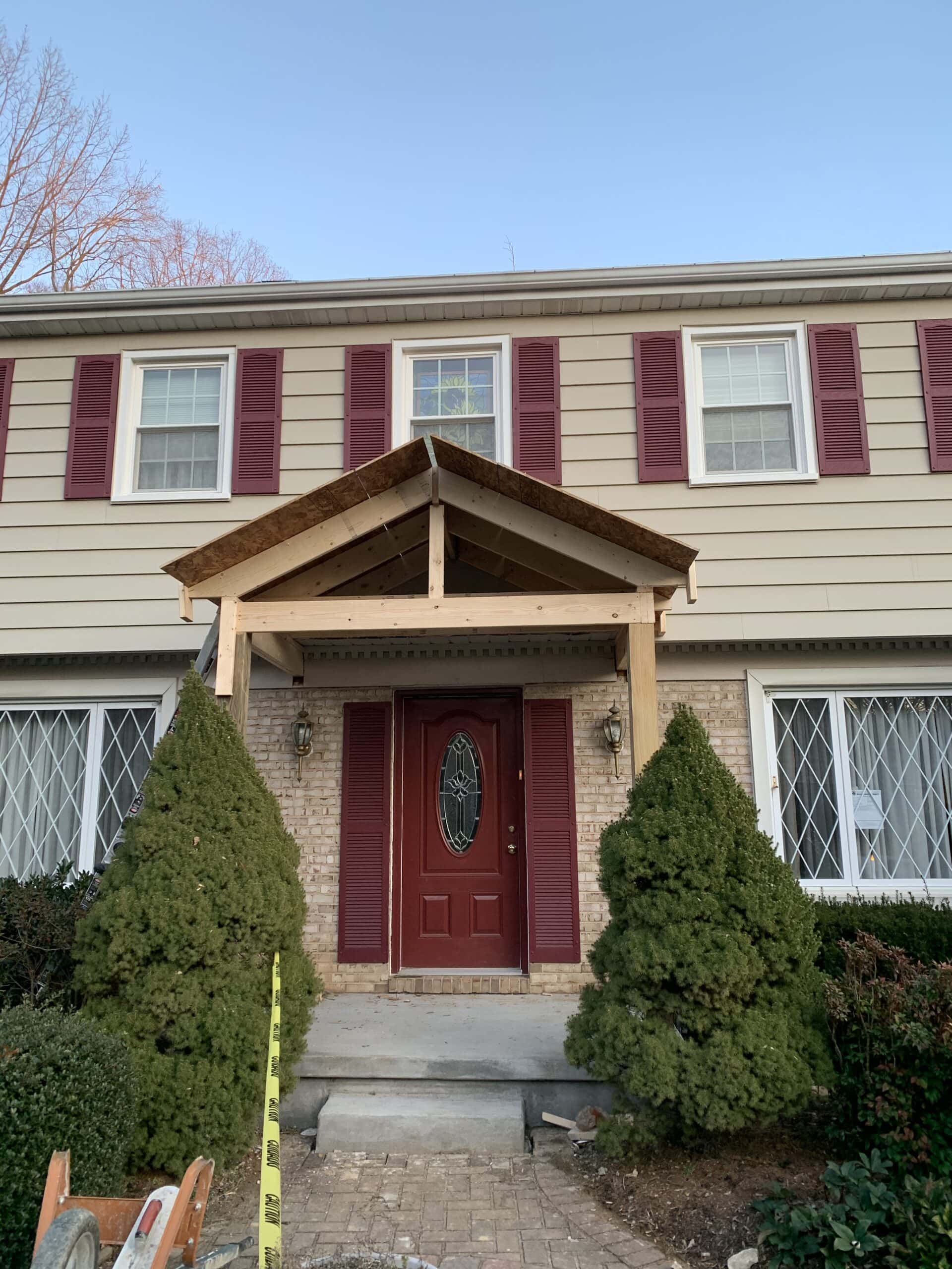 Progress photo showing completed wooden porch frame